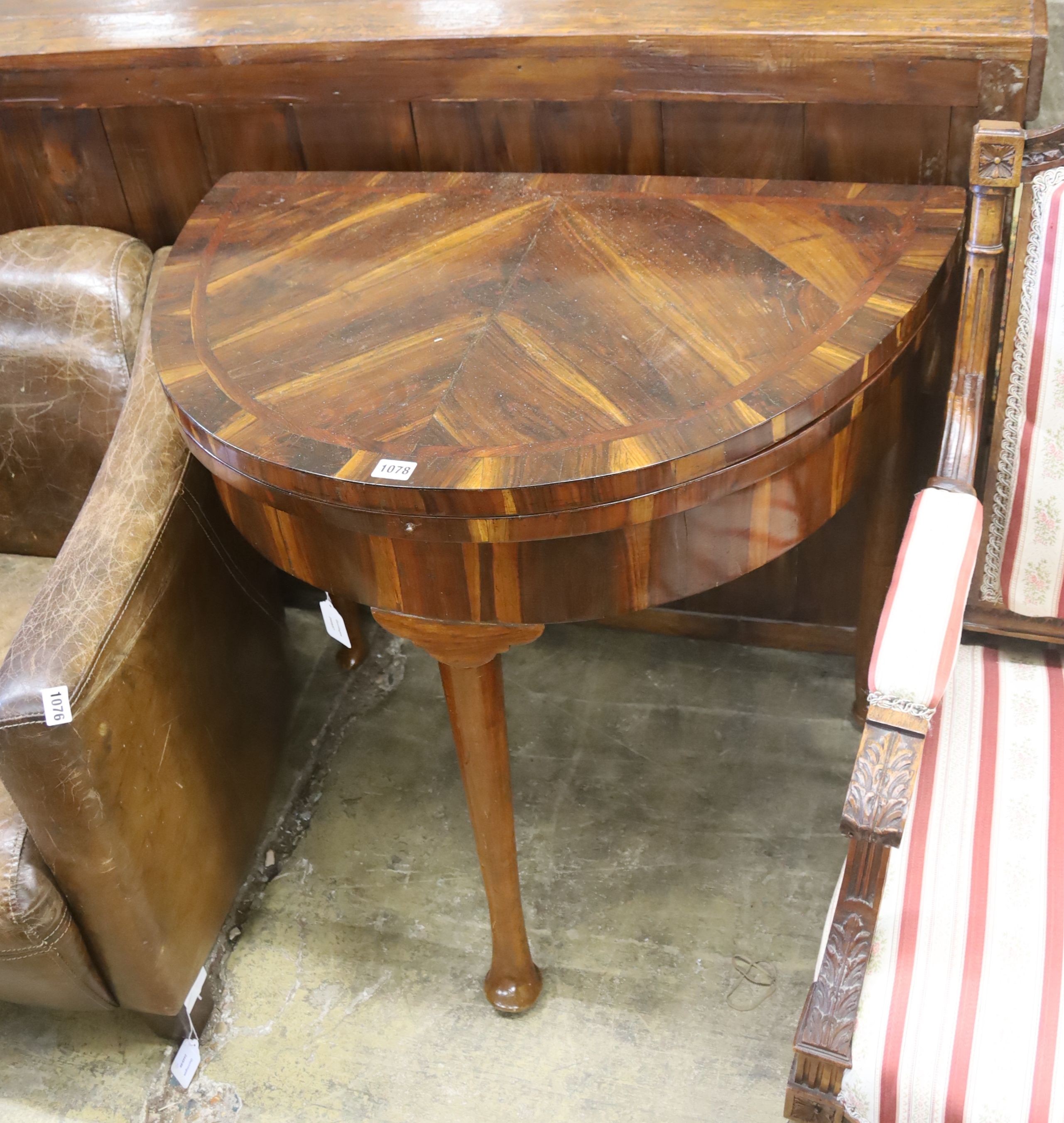 A 18th century Continental Goncalo Alves demi-lune card table with folding top, width 84cm, depth 56cm, height 76cm